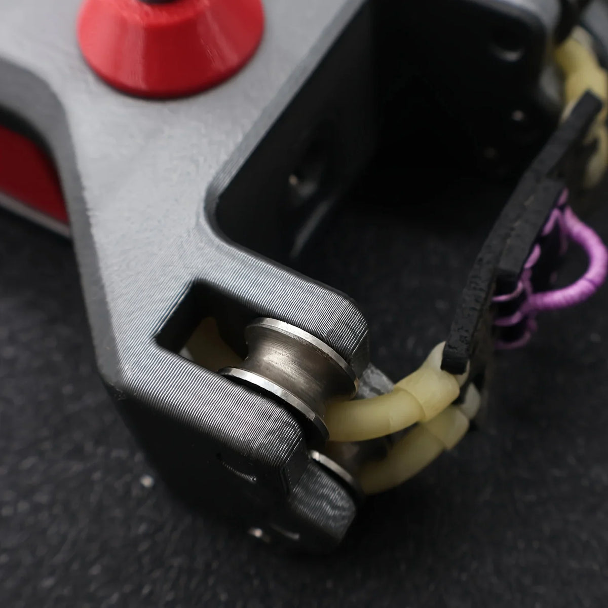Close-up of the metal wheel and band mechanism on a slingshot