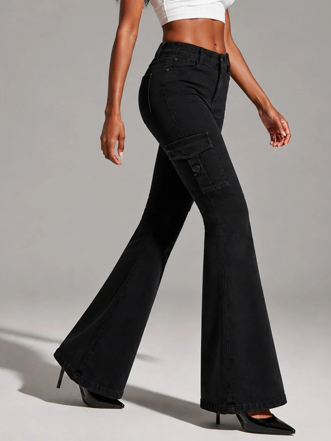 Black cargo flare jeans, side view, worn by a model.