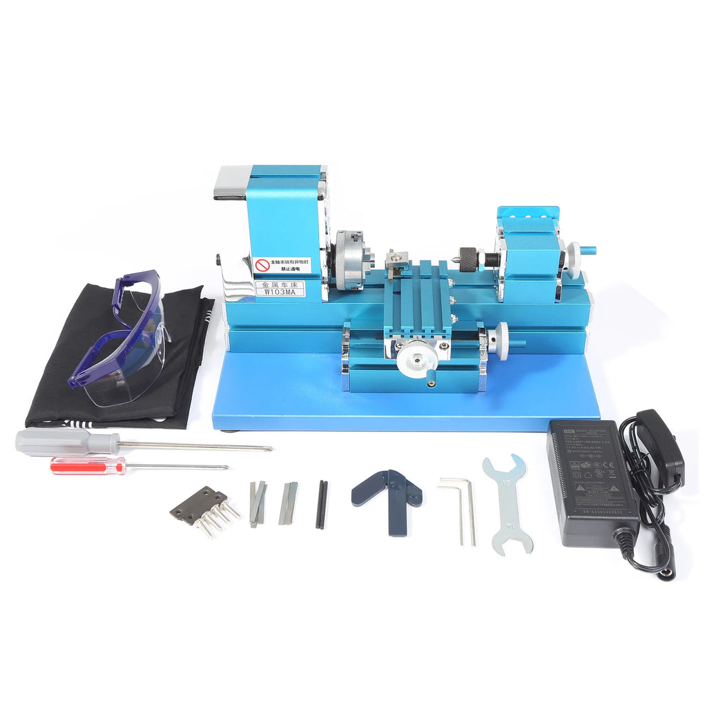 Mini lathe machine with accessories including screwdriver and safety glasses