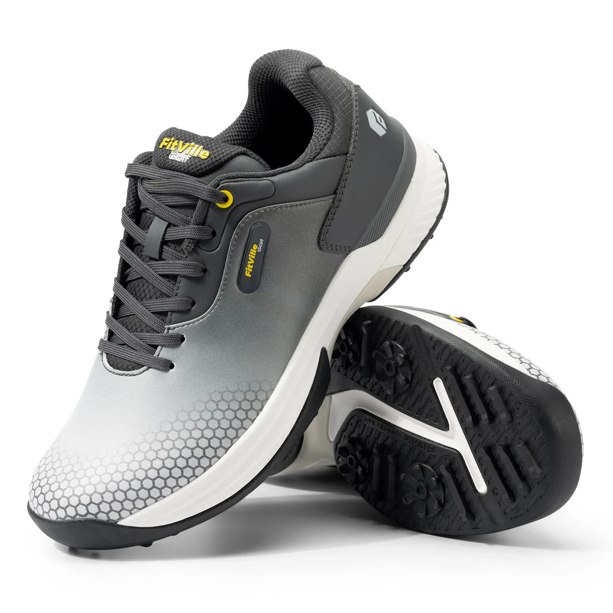 A pair of grey and white gradient golf shoes with a honeycomb pattern on the front.