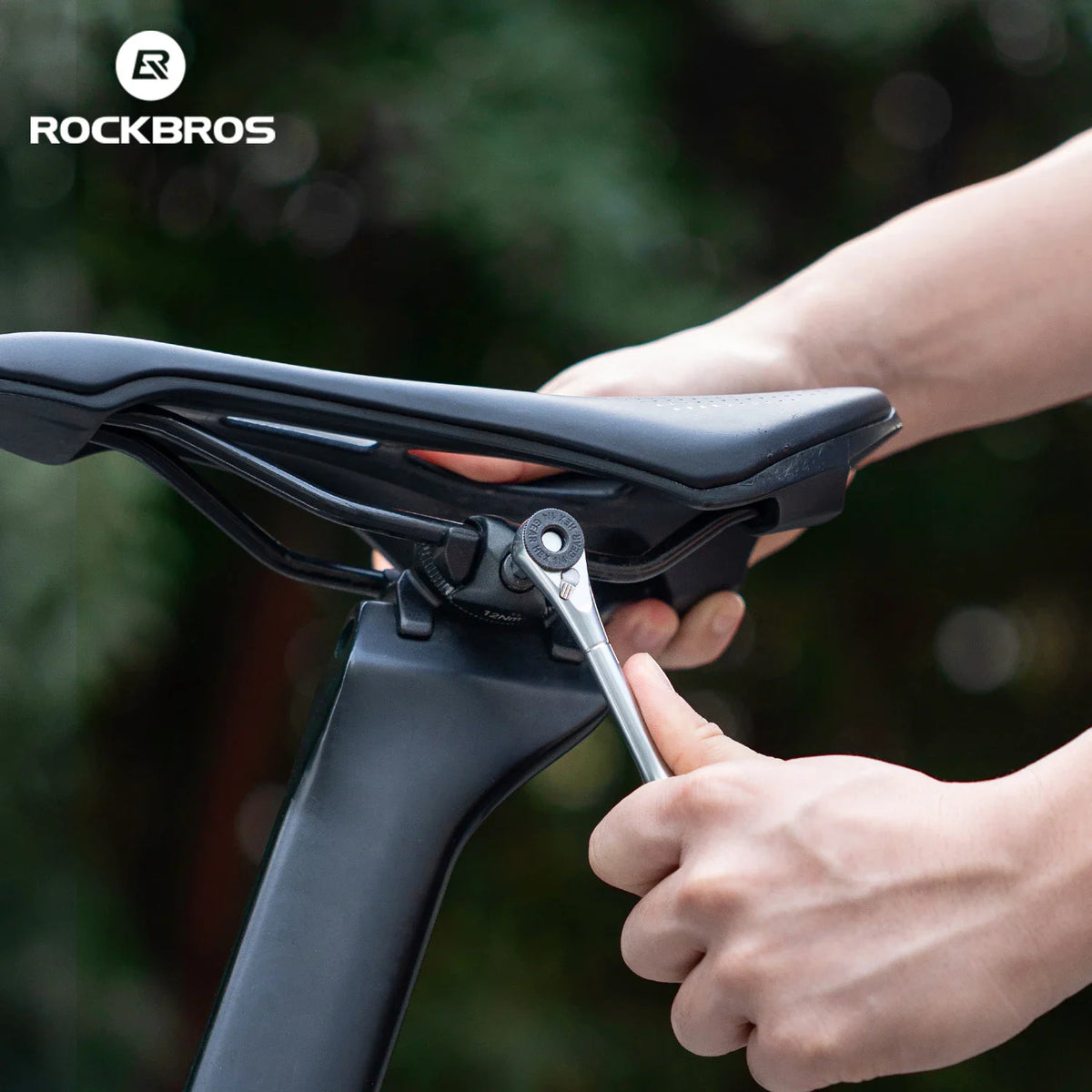 Person using a ratchet wrench to adjust a bicycle seat post clamp