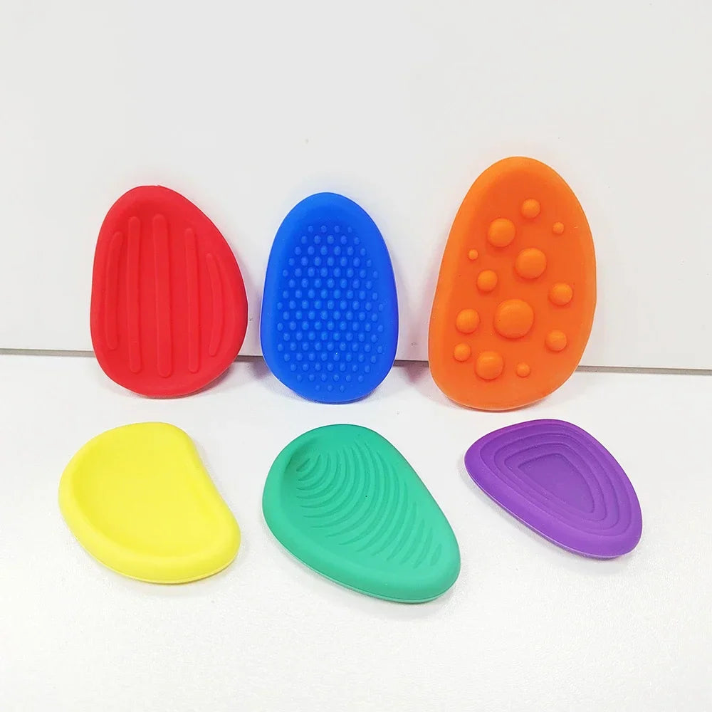 Collection of 6 colorful textured silicone stones for sensory play