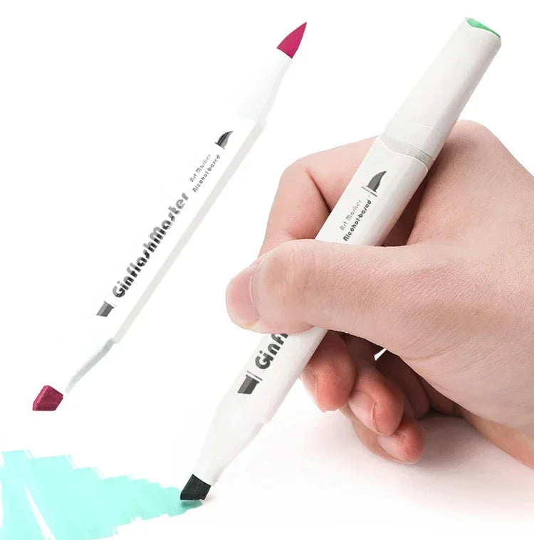 A hand holding a dual-tip art marker demonstrating its use for drawing on paper