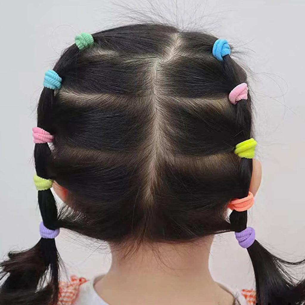 Back view of a girl's hairstyle with braids secured by small colorful seamless hair elastics