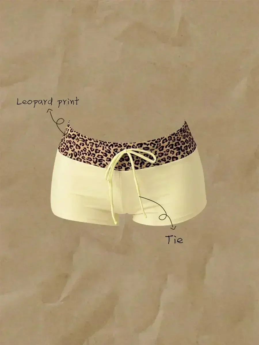 High waisted bikini bottoms featuring a leopard print waistband and pale yellow lower section with drawstring detail