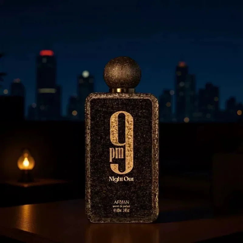 A black textured men's perfume bottle placed on a table in front of a night city skyline.