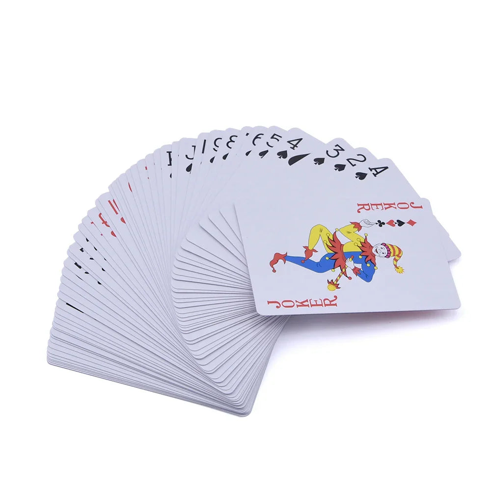 A full deck of playing cards fanned out showing the joker on top.