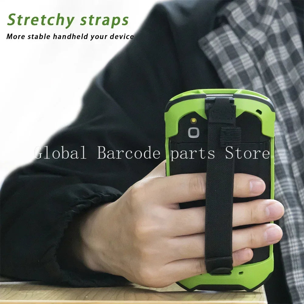Hand holding a rugged handheld scanner with a protective green case and handstrap
