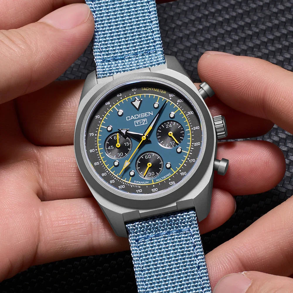 Handheld view of a blue dial chronograph watch with a light blue canvas strap