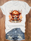 White short-sleeve t-shirt with a highland cow coffee print, worn with denim shorts.
