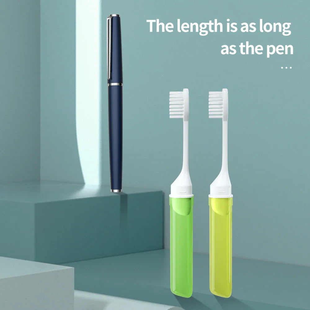 Two green foldable toothbrushes next to a blue pen for size comparison