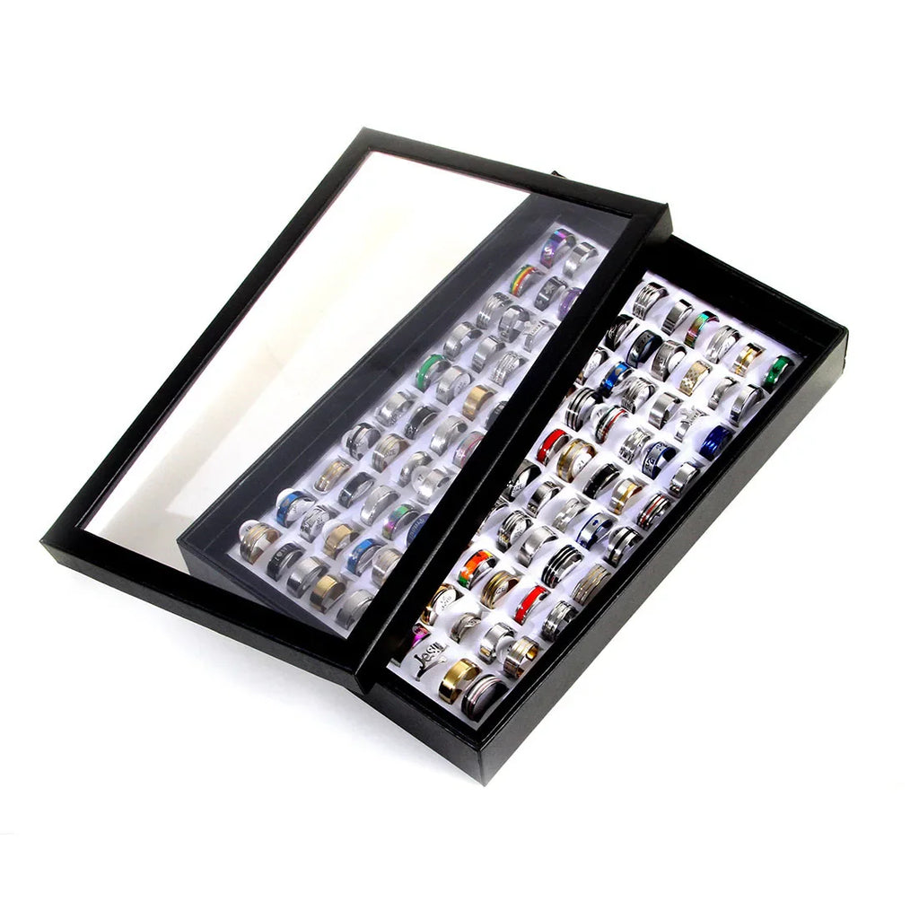 Two large trays containing a wholesale lot of mixed metal finger bands for men and women.