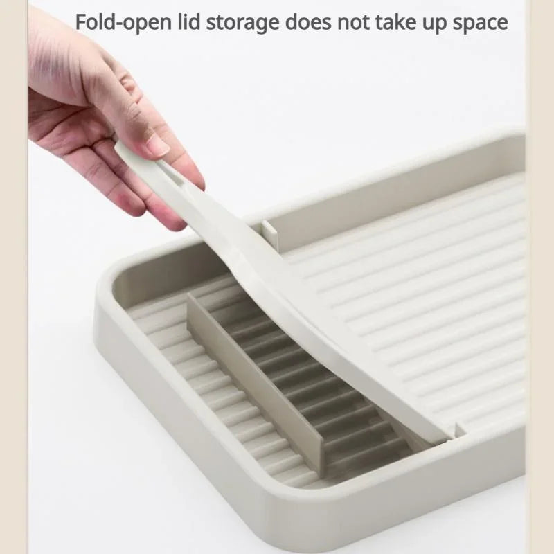 A hand opening the foldable support stand on a beige kitchen utensil rest.