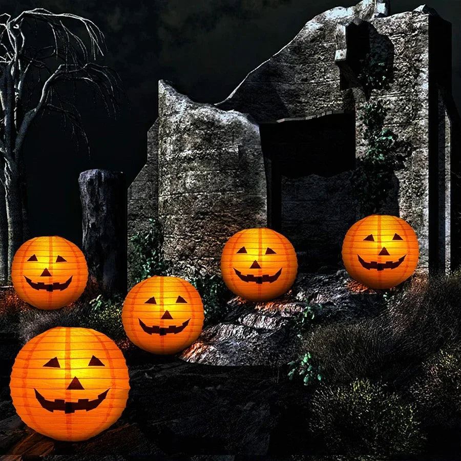 Orange jack-o'-lantern paper lanterns glowing in a spooky graveyard scene