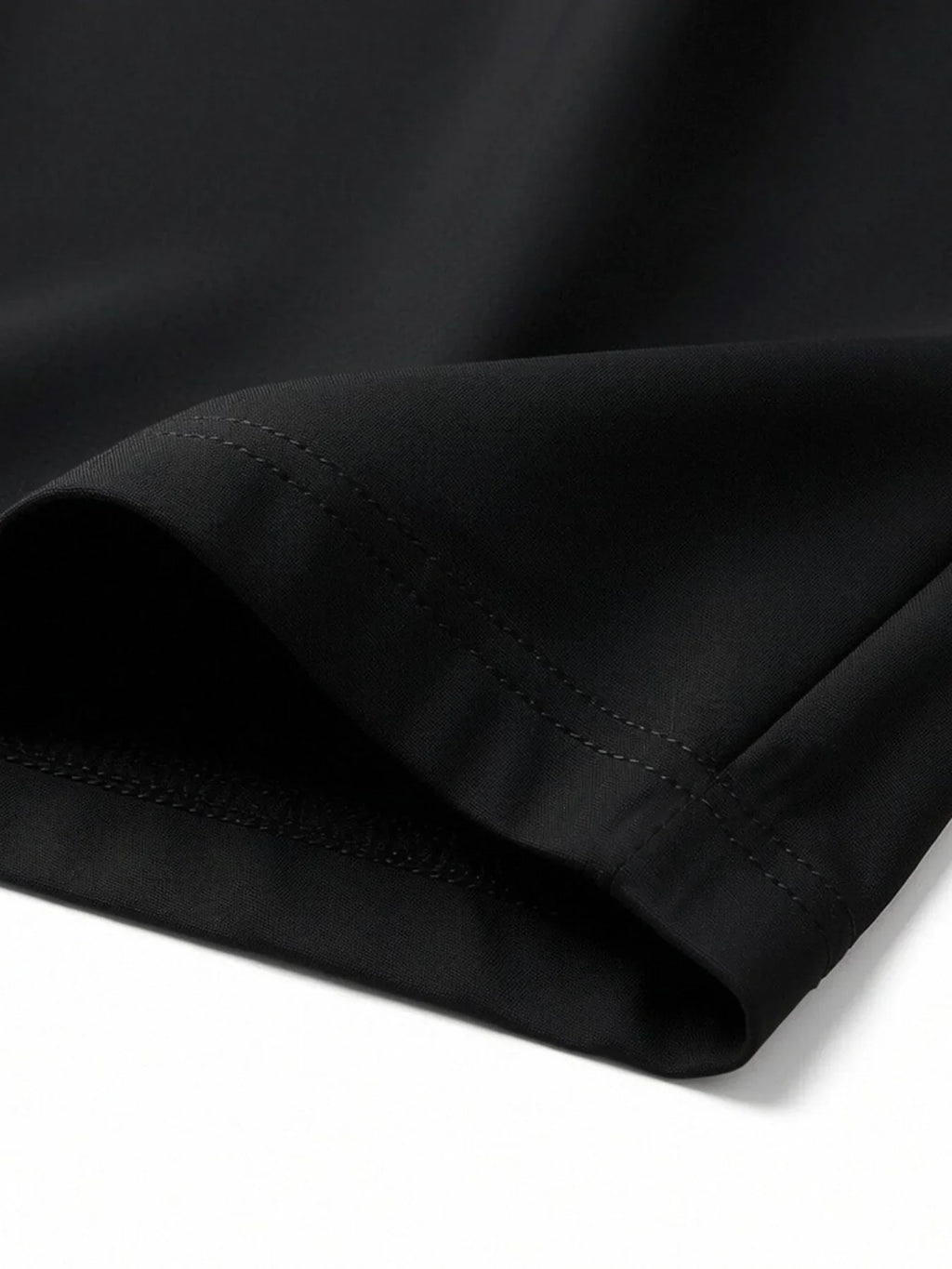 Close-up of hem and stitching detail on black athletic shorts