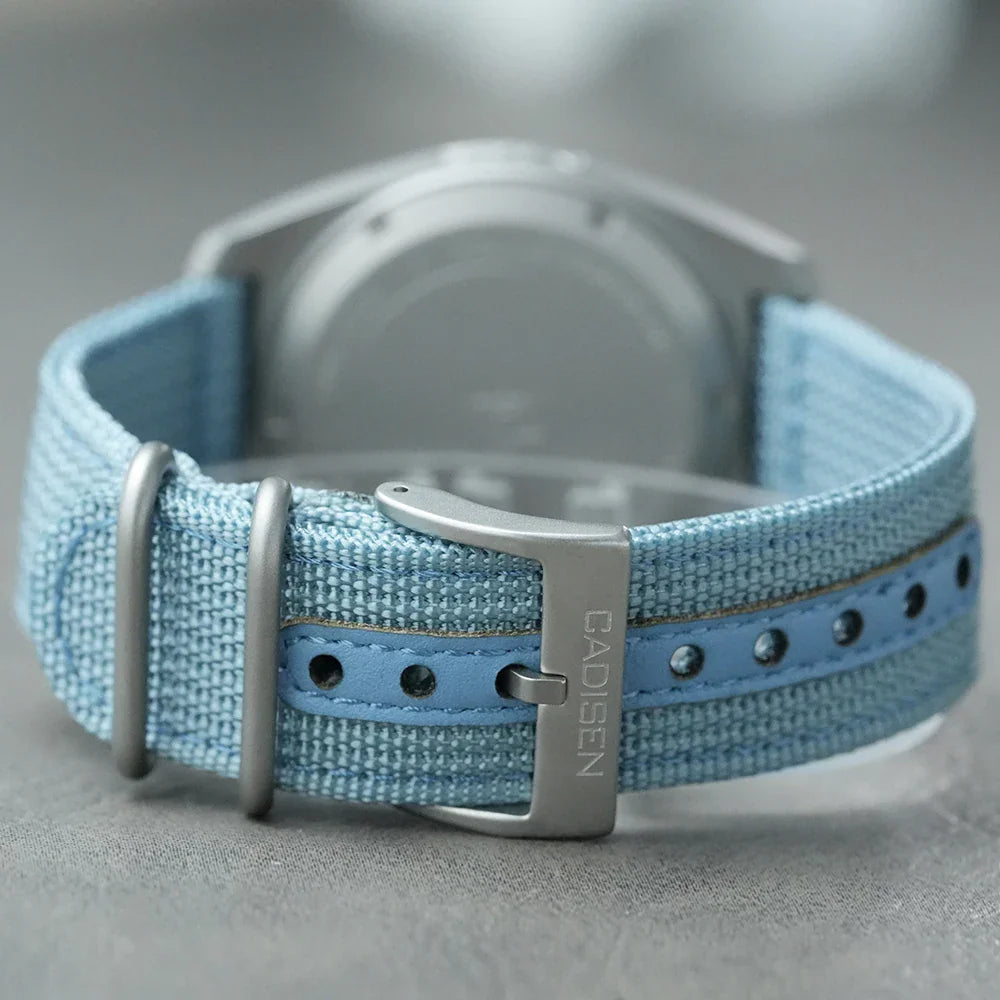 Buckle and strap view of a chronograph watch with a light blue canvas band