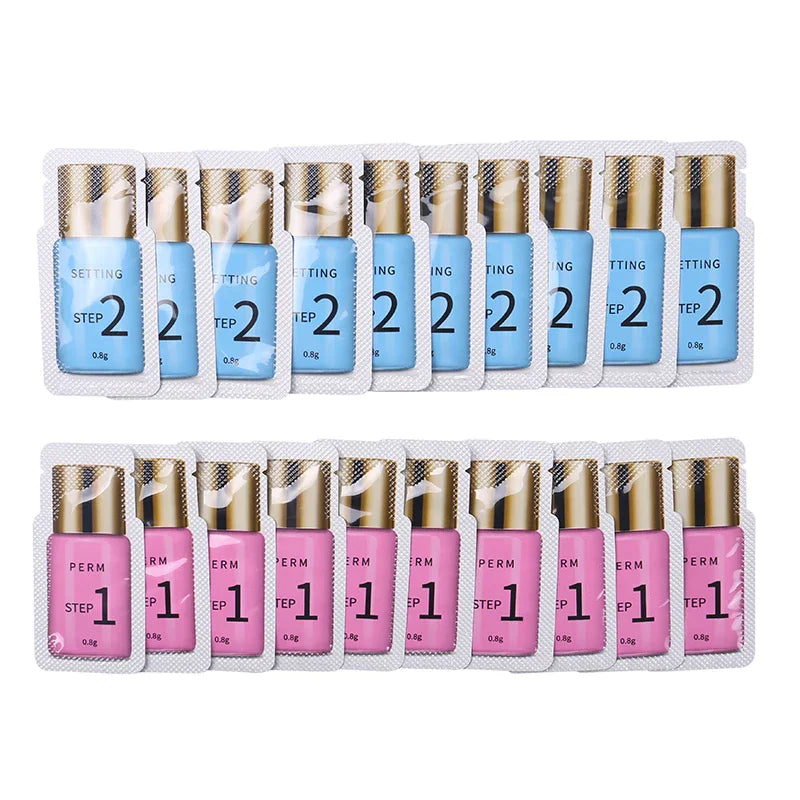 Multiple sachets of blue setting lotion and pink perm lotion for eyelash lifting