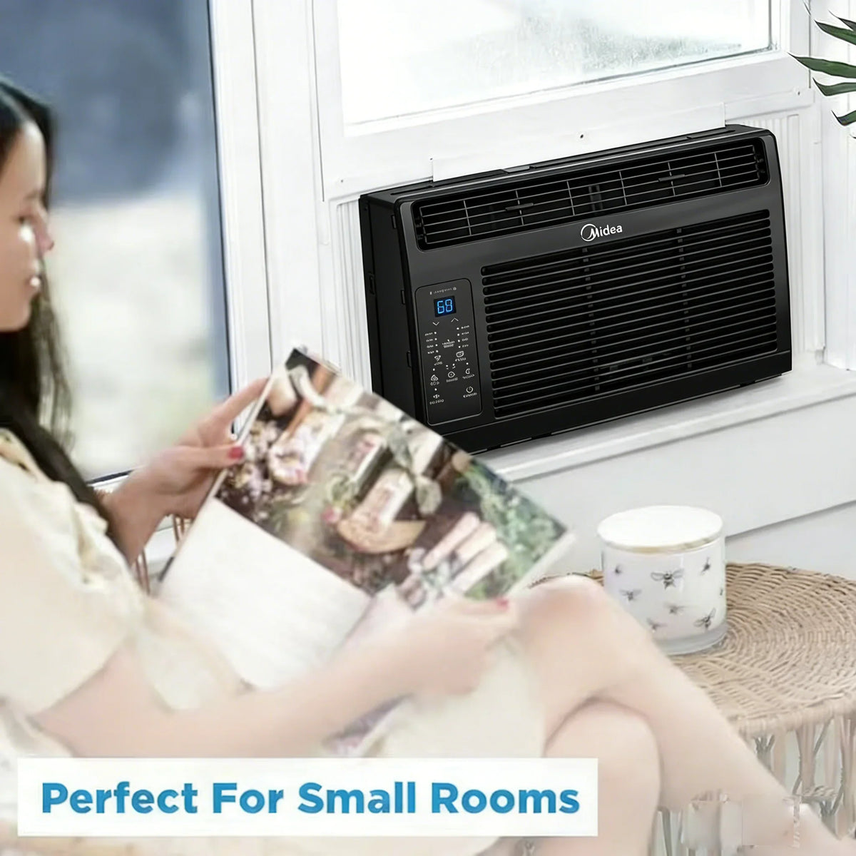 Woman sitting near a black window air conditioner in a small room