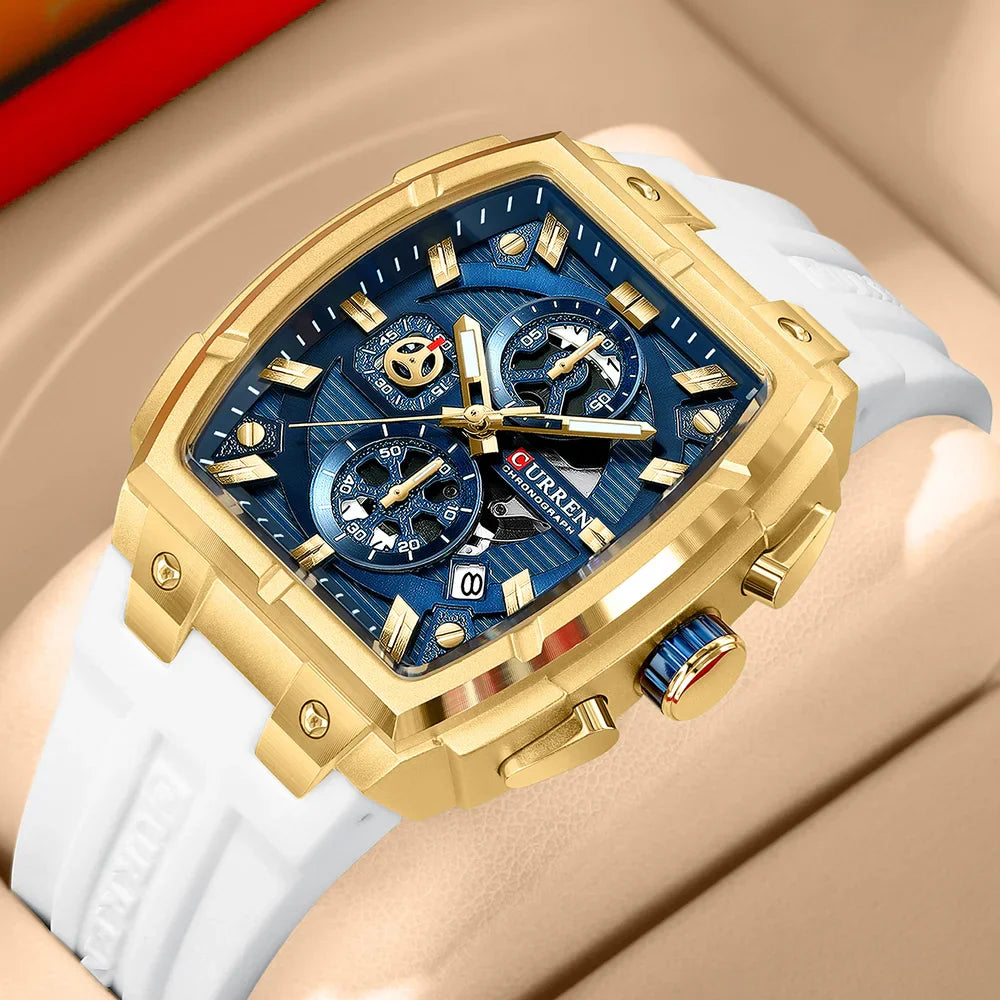 Men's square chronograph watch with gold case, blue dial, and white silicone strap