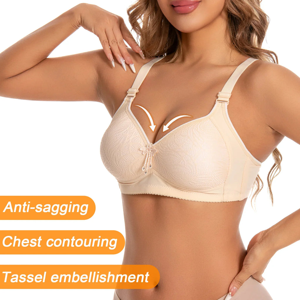 A woman wearing a beige wireless bra with features like anti-sagging, chest contouring and tassel embellishment