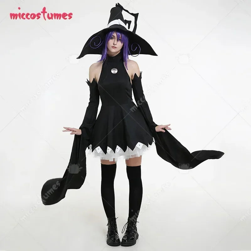 A woman wearing a black sleeveless witch cosplay dress and matching hat