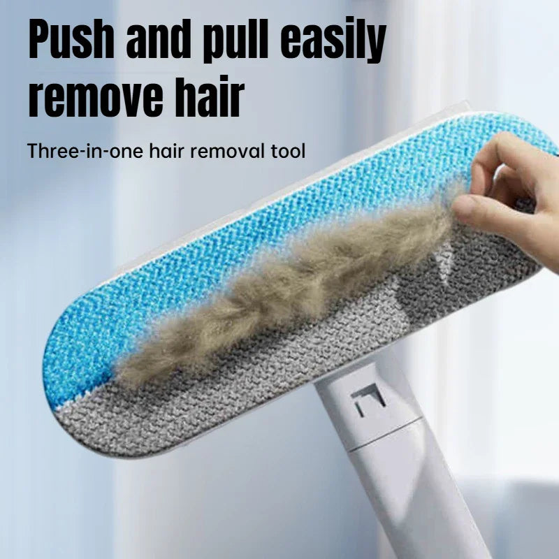 Handheld long-handle pet hair removal tool with blue and grey scrubbing head cleaning lint off fabric