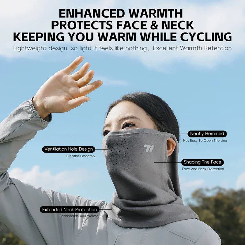 A woman wearing a grey thermal face mask for cycling, showing features like ventilation and hem detailing