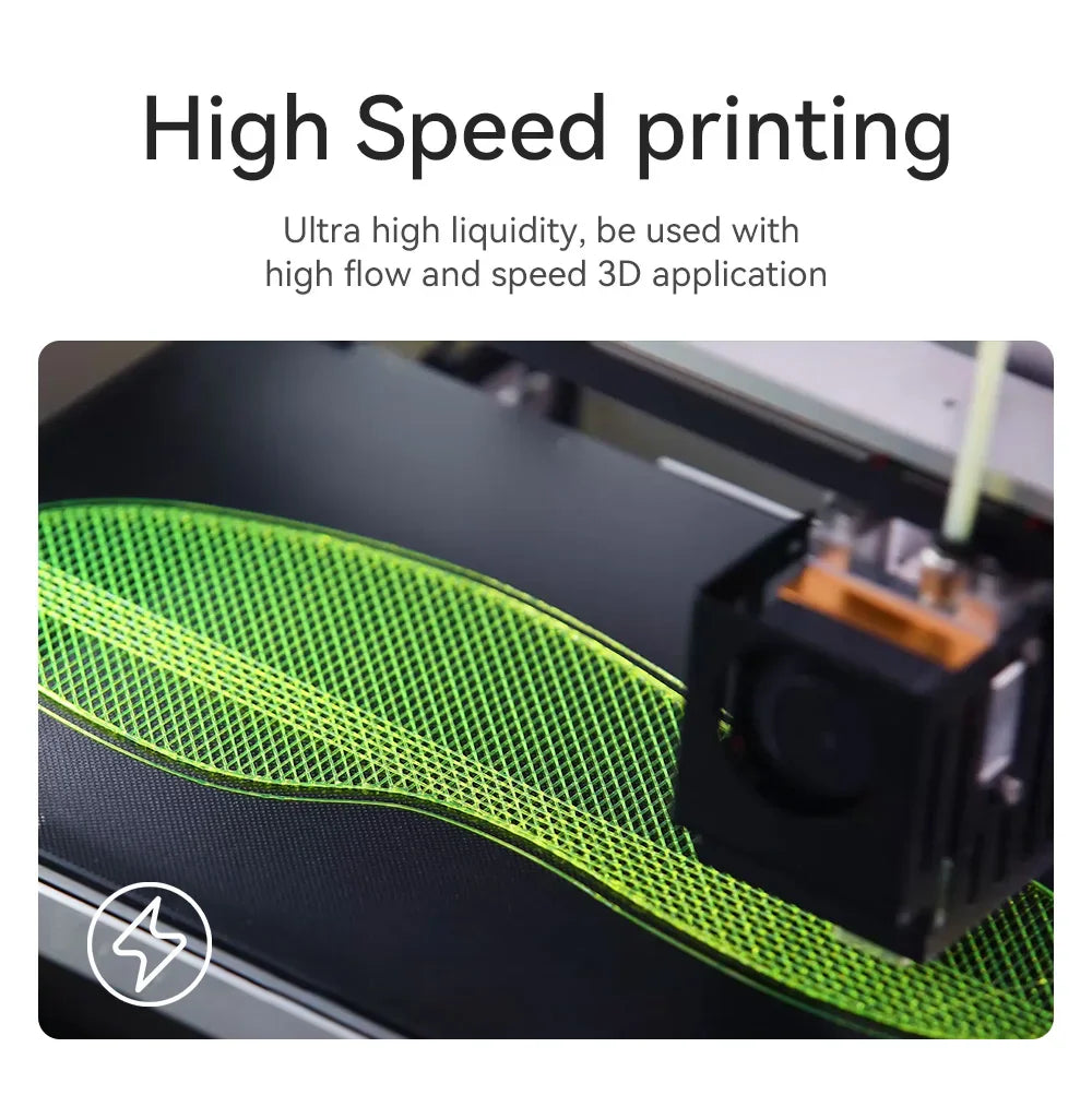 Close-up of a 3D printer nozzle printing a green flexible pattern on a build plate.