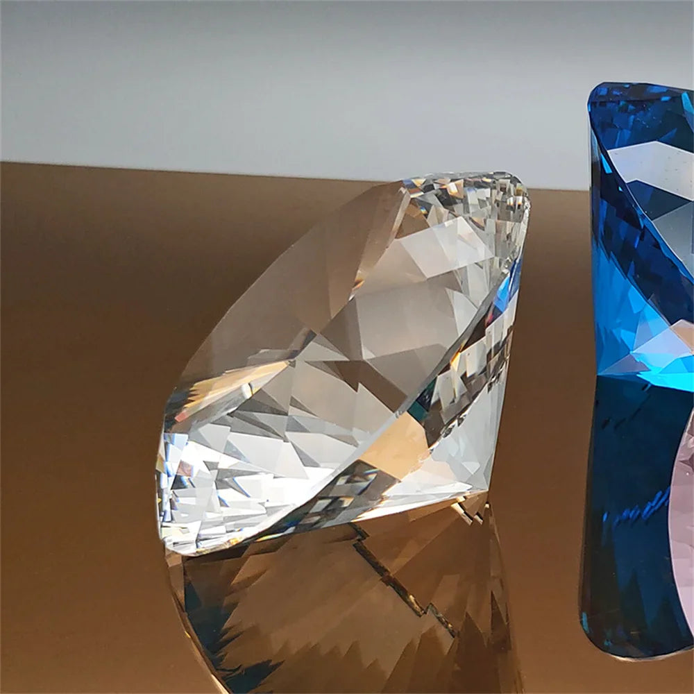 Clear diamond-shaped crystal paperweight reflecting on a bronze surface