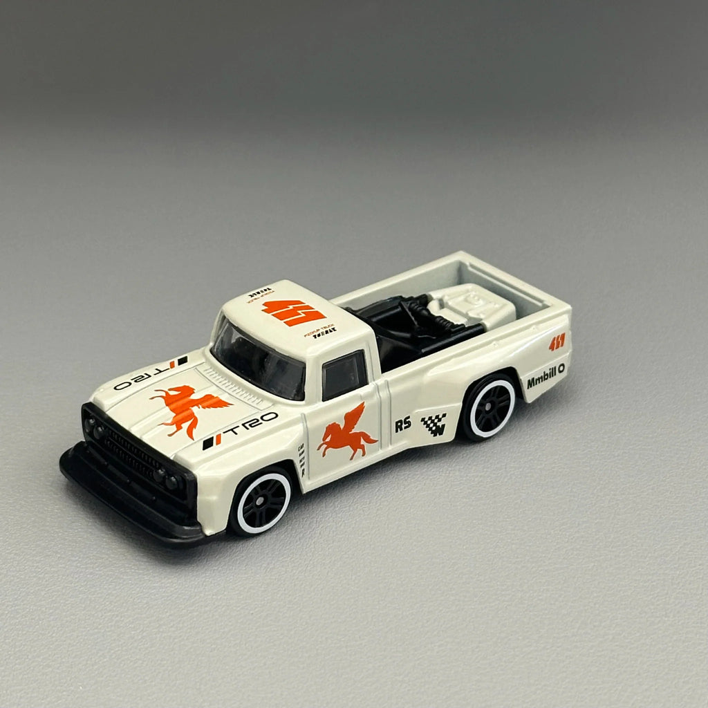 White diecast pickup truck toy model from a high angle