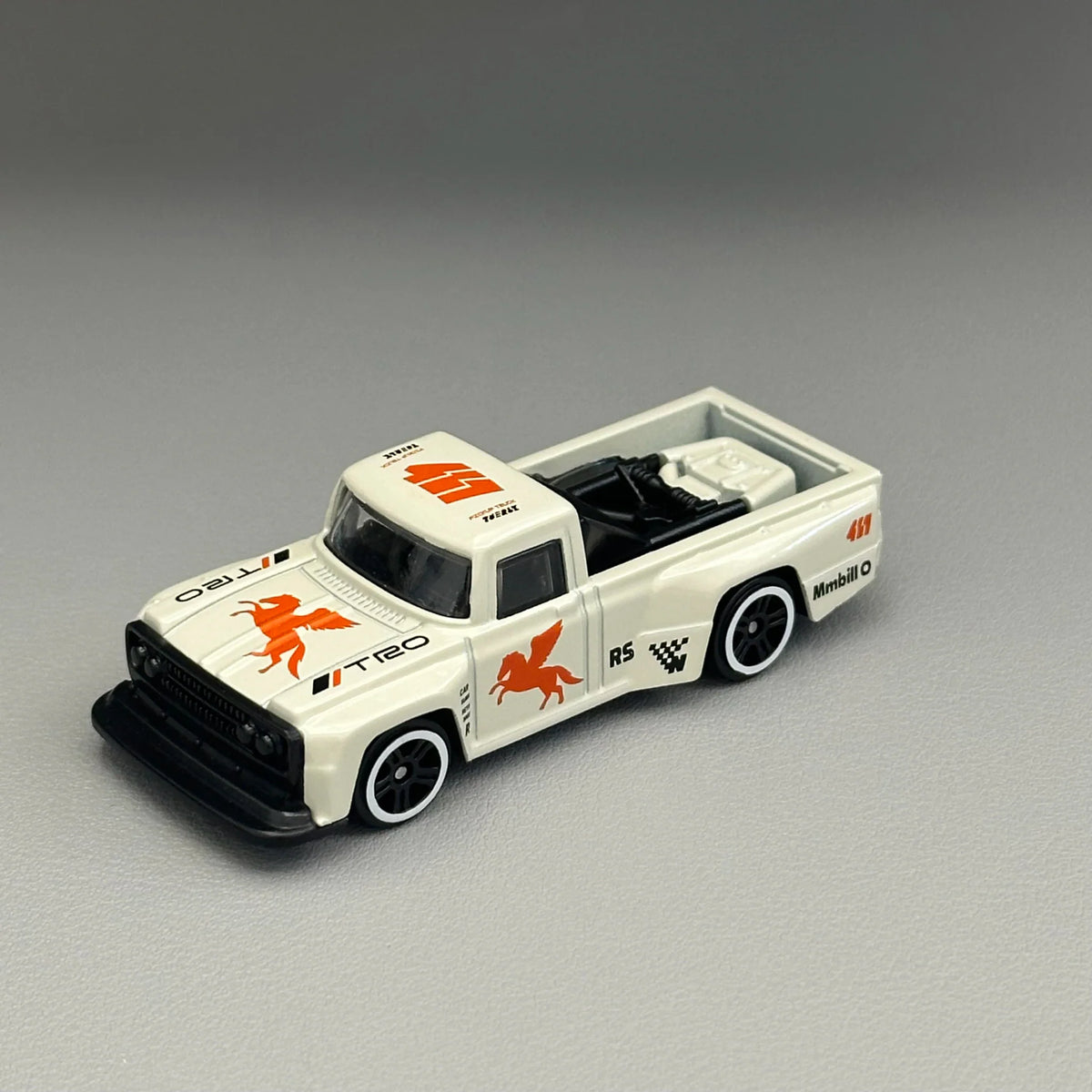 White diecast pickup truck toy model from a high angle