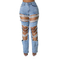 Light wash blue denim jeans with crystal rhinestone fringe and large distressed cutouts