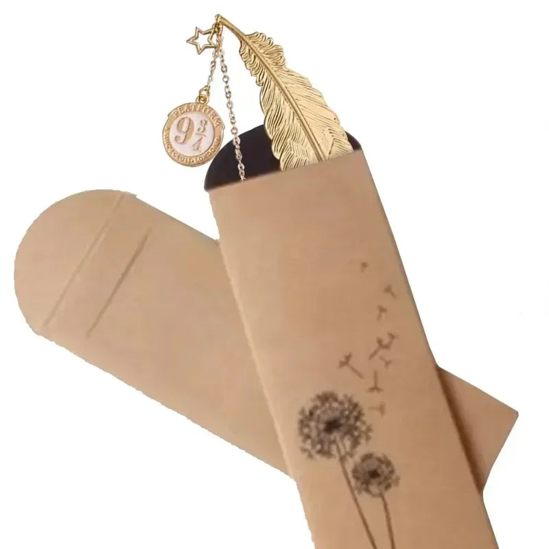 Golden metal feather bookmark with platform 9 3/4 charm in a decorative paper sleeve