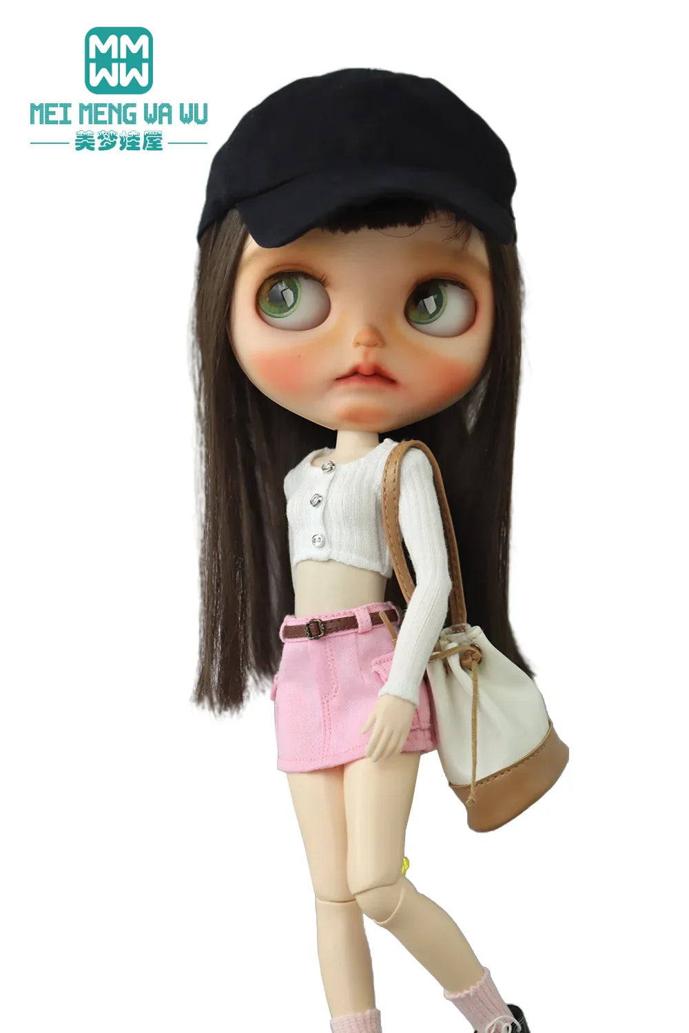 Doll in a black cap, white long sleeve cropped knit top, light pink miniskirt and bag