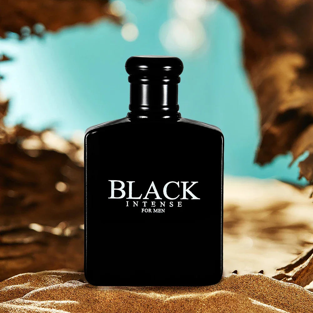 Black bottle of men's eau de toilette perfume featuring the label Black Intense for Men on a sandy surface