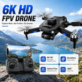 Black foldable drone with camera and remote controller with smartphone holder in mountain landscape