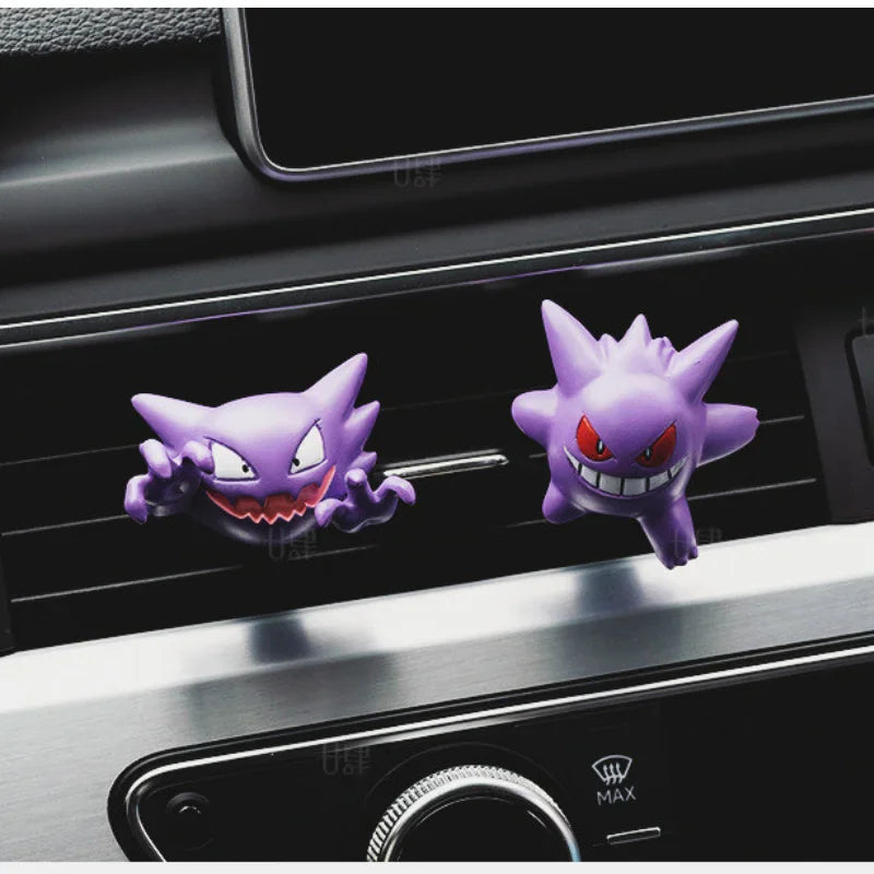 Two ghost type monster figures clipped onto a car air conditioning vent