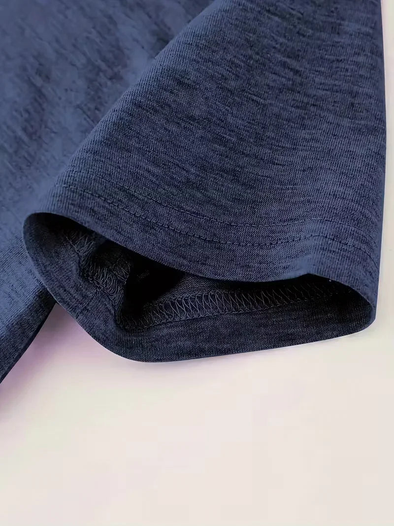 Close-up of the sleeve and hem of a blue short sleeve t-shirt