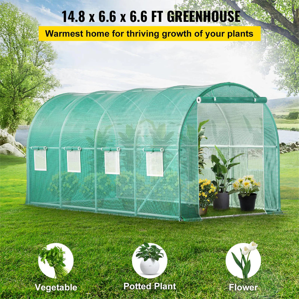 Large tunnel greenhouse with plants inside, suitable for vegetables, potted plants, and flowers.