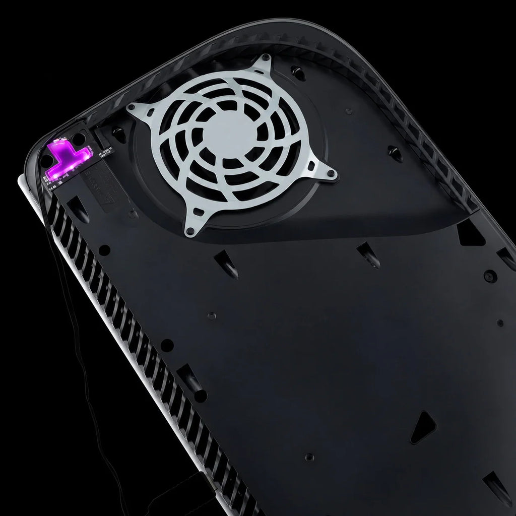 Internal view of a console with purple illuminated RGB LED logo light kit installed next to the cooling fan.
