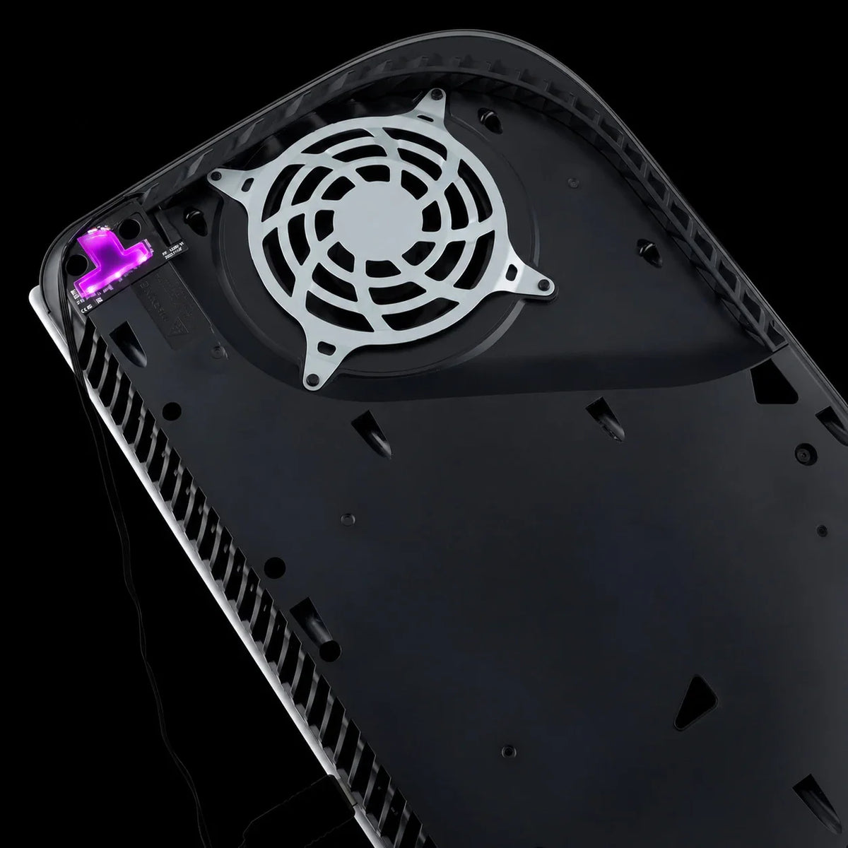 Internal view of a console with purple illuminated RGB LED logo light kit installed next to the cooling fan.