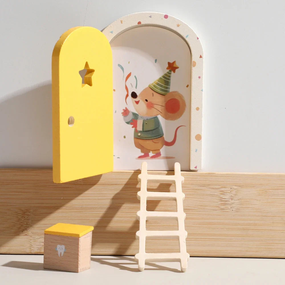 Miniature wooden fairy door set with a ladder and a small tooth storage box