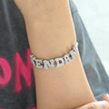 Custom alphabet letter slide bracelet with a double mesh chain in a metallic finish.