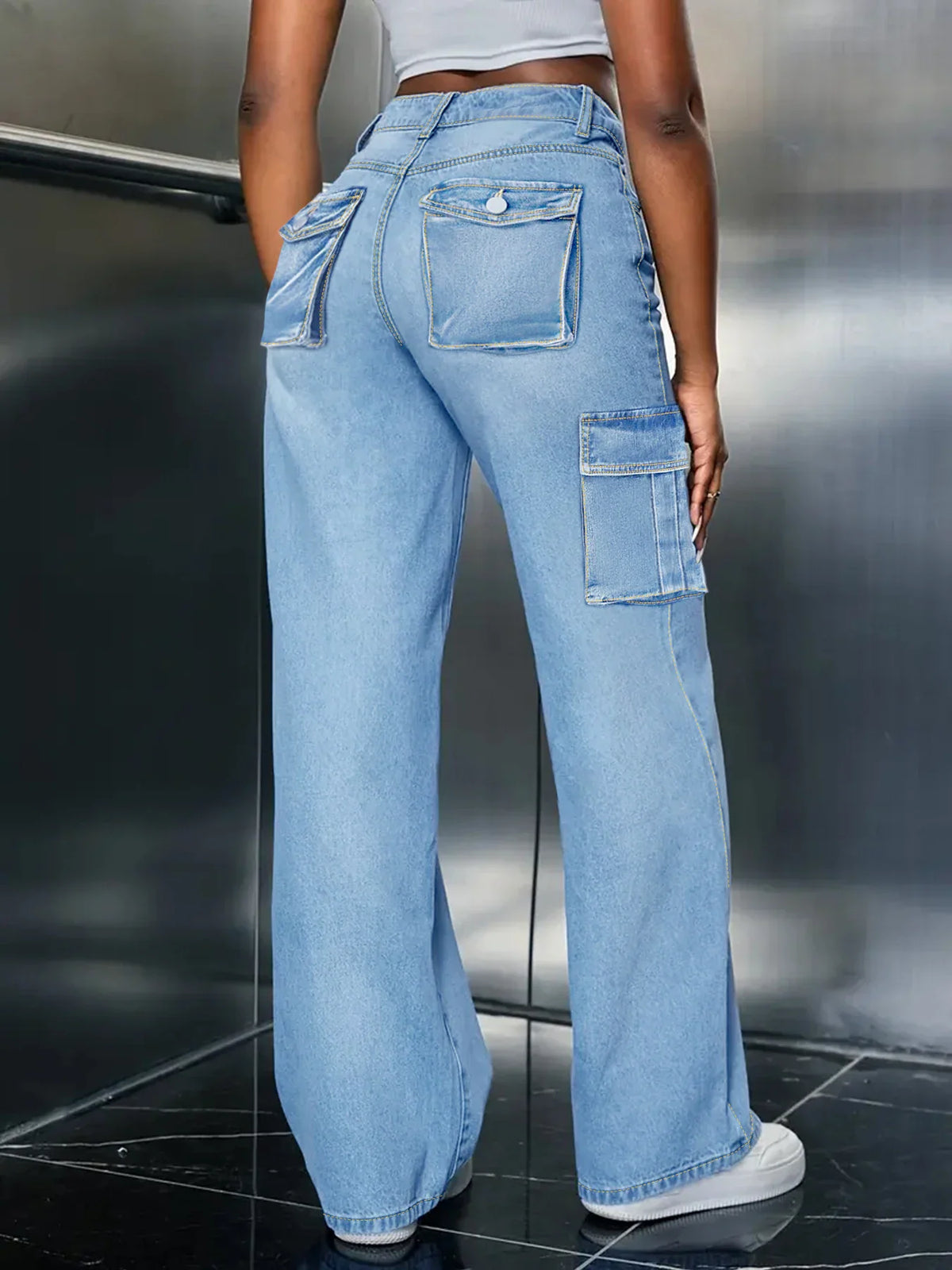 Rear view of light blue denim cargo jeans with back pockets and straight leg fit.