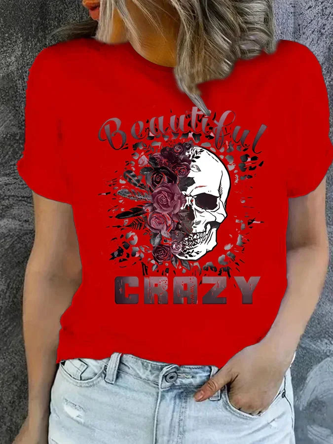 Red short sleeve t-shirt with floral skull graphic and text on a woman