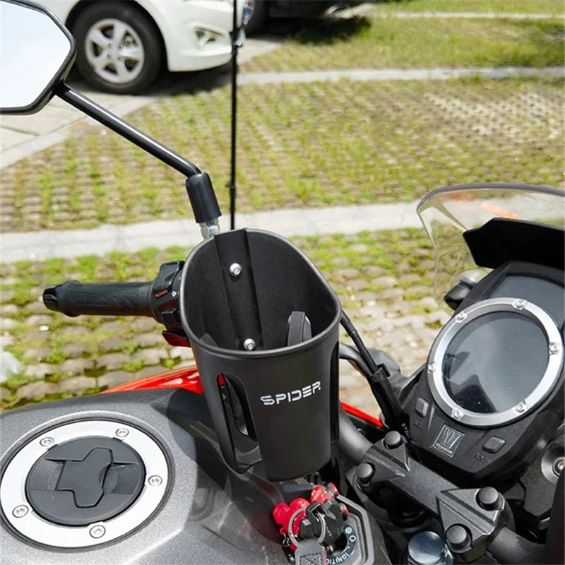 Black plastic motorcycle cup holder installed on handlebars