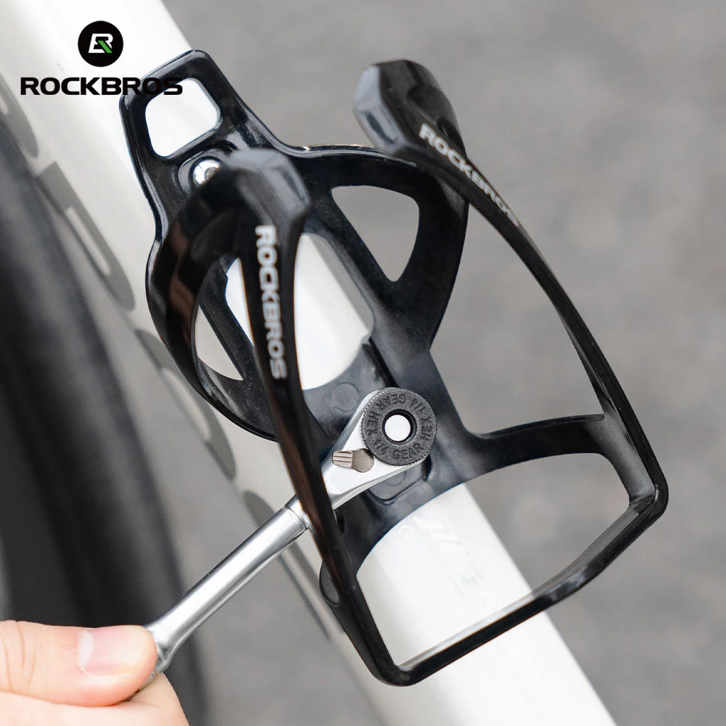 Person using a ratchet wrench to tighten a bicycle water bottle cage bolt