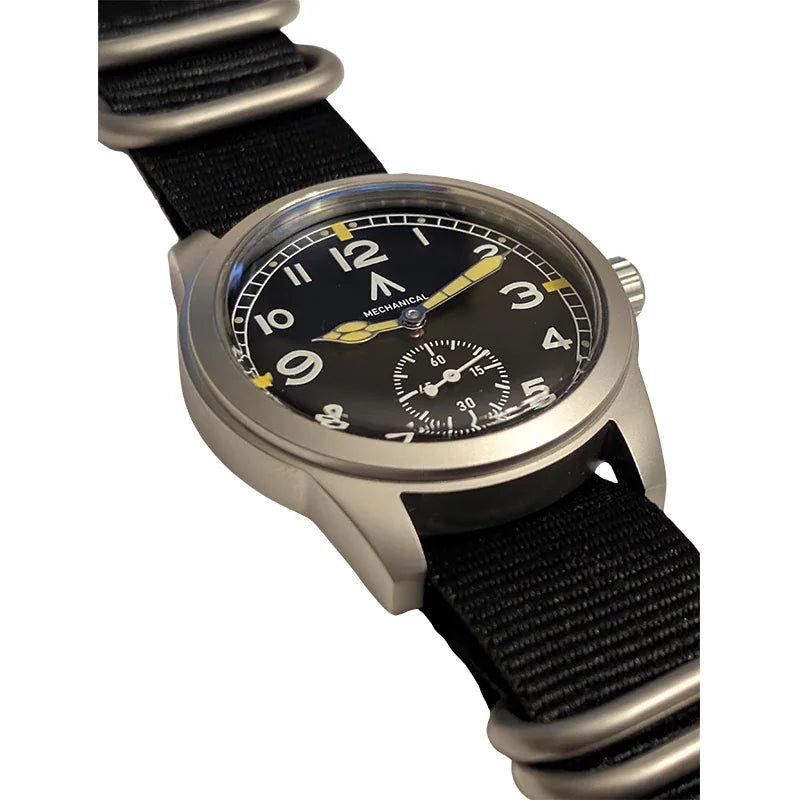 Angled view of black dial field watch with yellow accents and sub-seconds dial on nylon strap