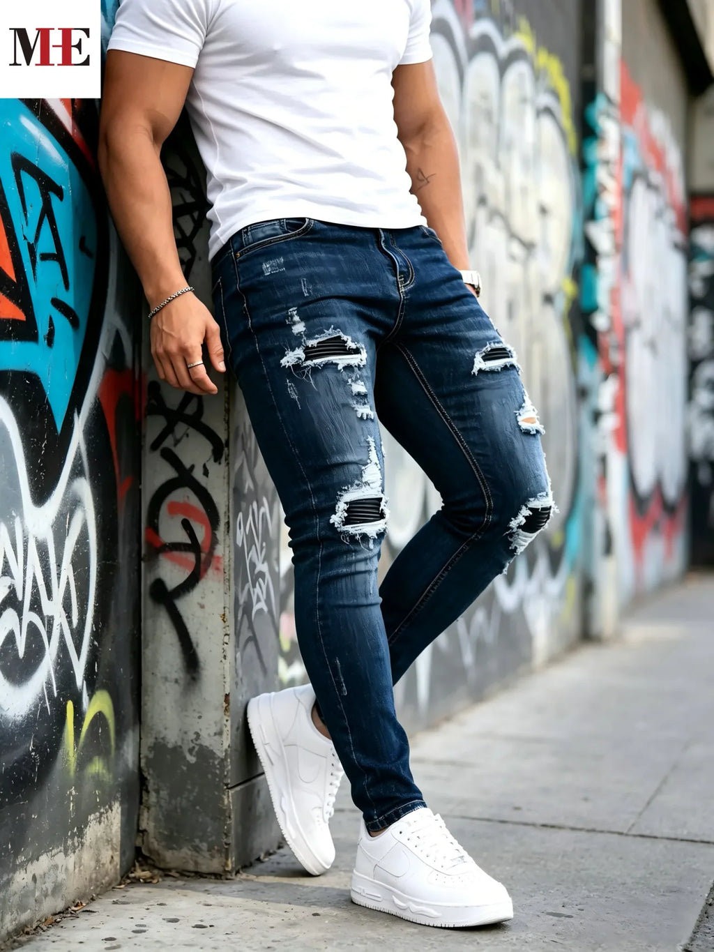 Dark blue slim skinny jeans with black stripe patches on knees, side view