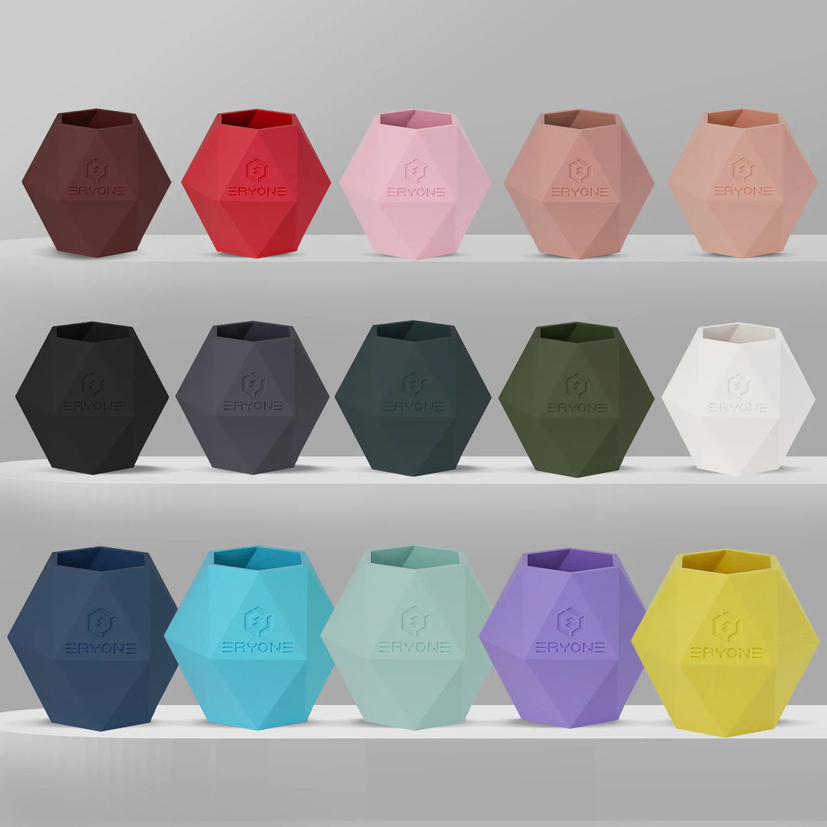 Collection of geometric vases 3D printed in various colors of matte PLA filament.